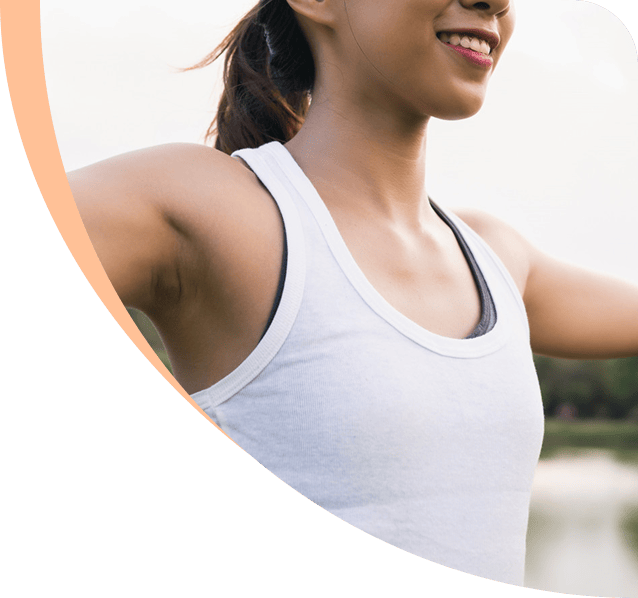 Woman stretching outdoors, representing wellness and urology care at Urology Alliance.