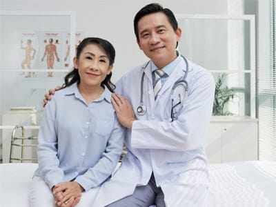 Urologist sitting with a patient during a consultation, representing compassionate care
